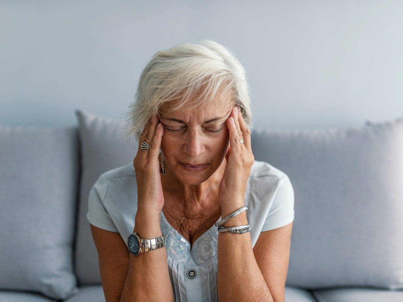 woman in seat with headache