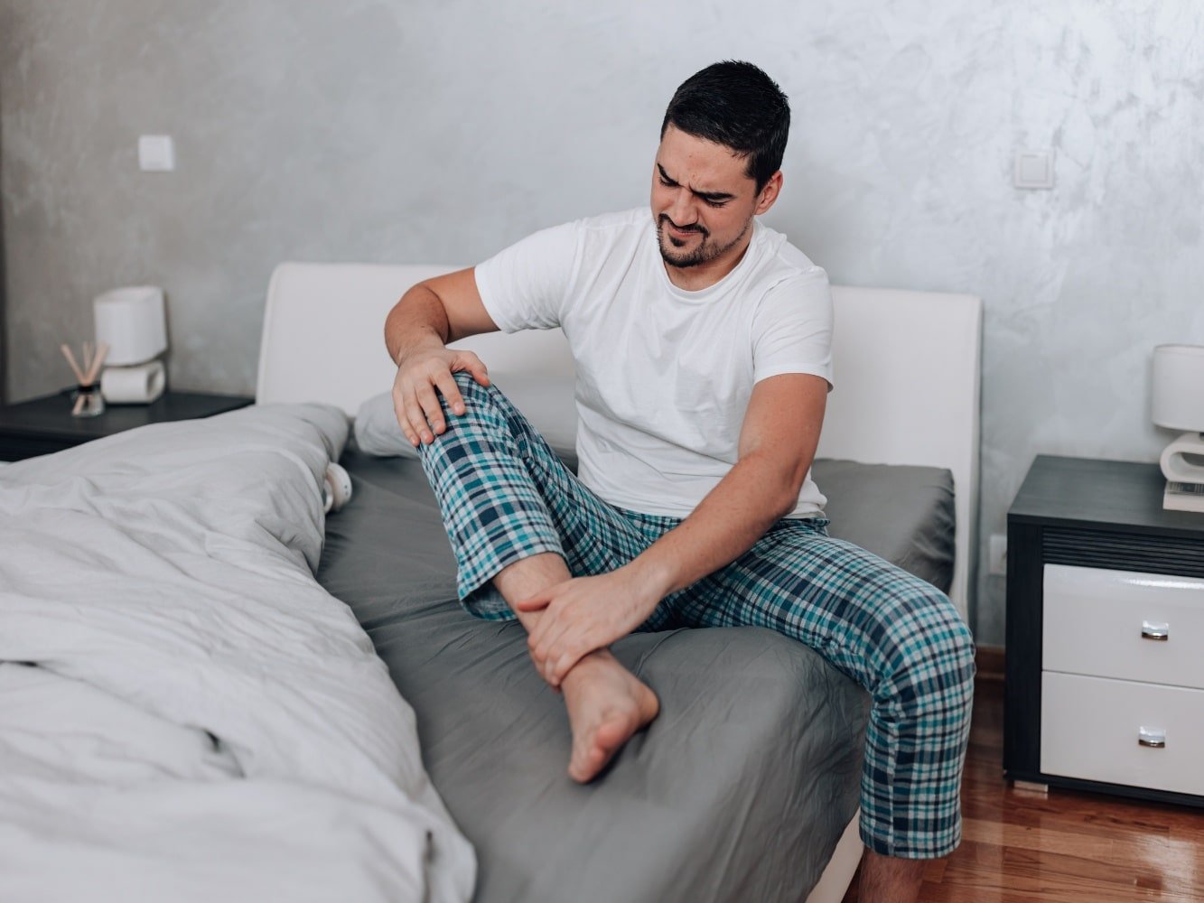 man in pajamas with muscle pain whole body and tired